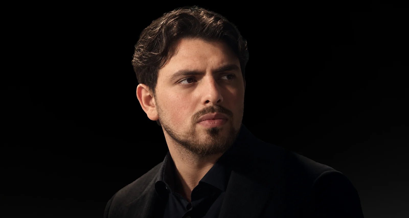 Alain Tural, landscape portrait against a dark background